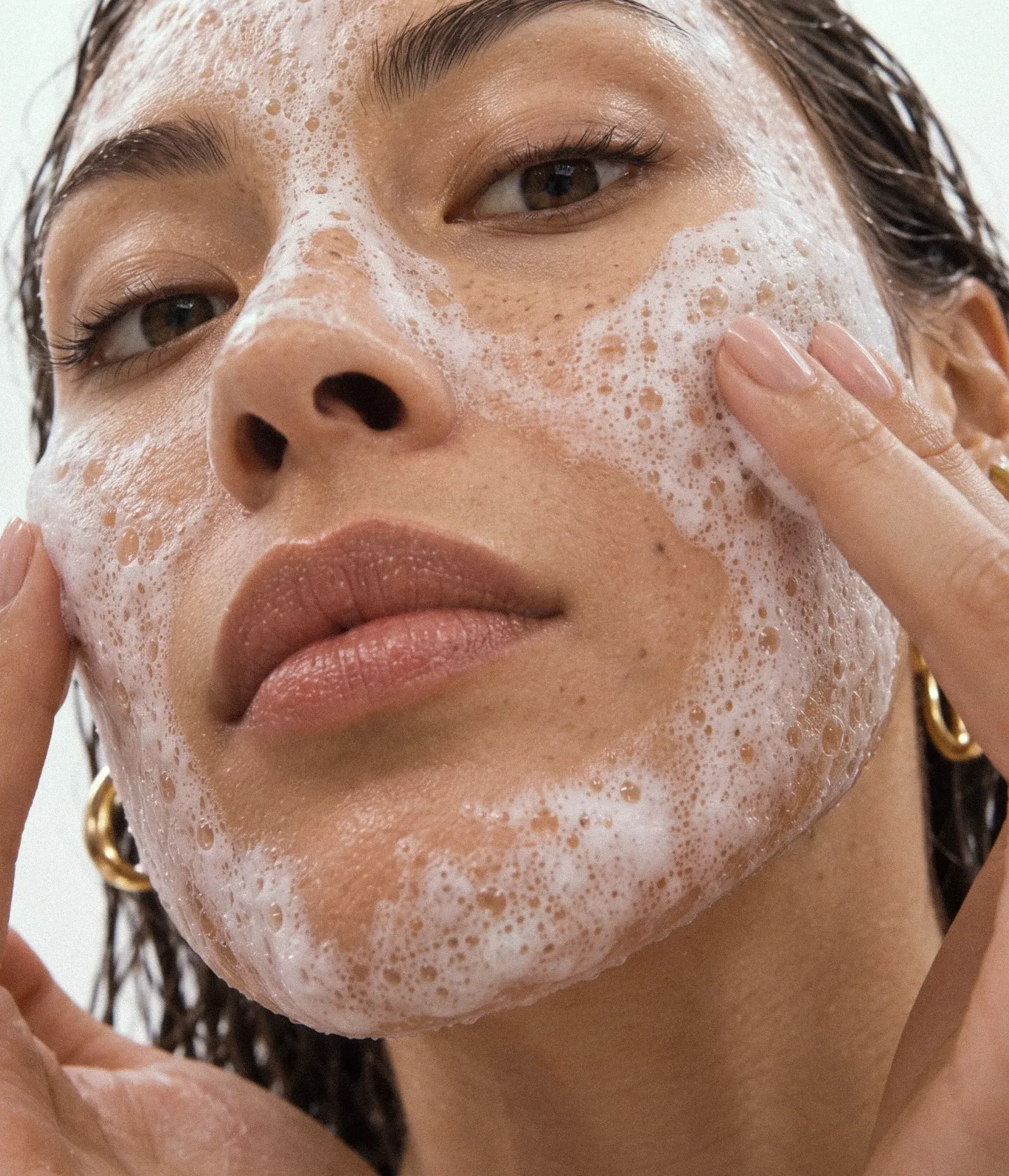 Portrait with cleansing foam on the face.