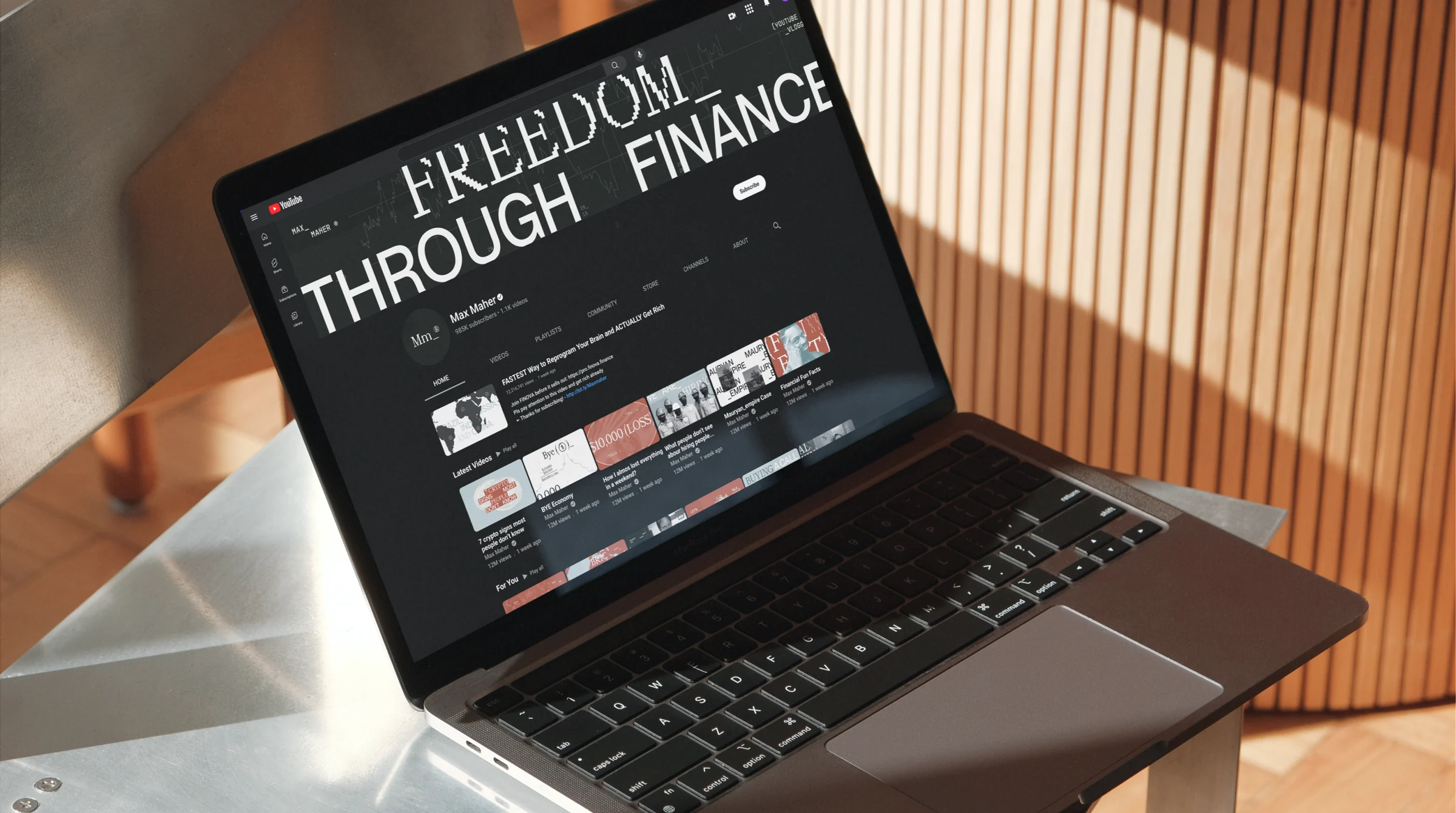 Max Maher website displayed on a laptop.