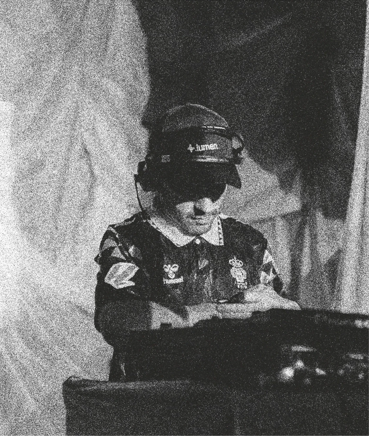 DJ wearing a Lumen cap and headphones at the mixing desk.