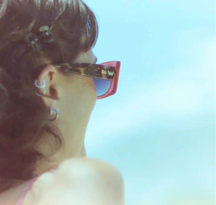 A profile portrait in red sunglasses.