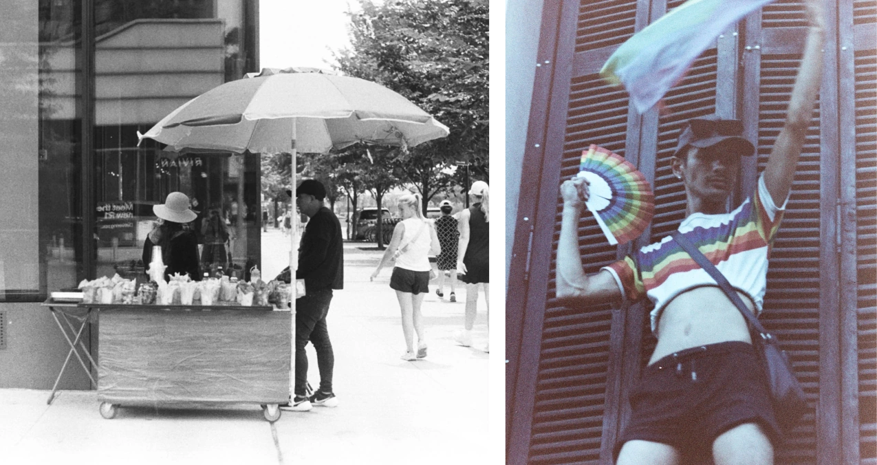 A black-and-white street vendor beneath an umbrella beside a person waving a colorful fan.