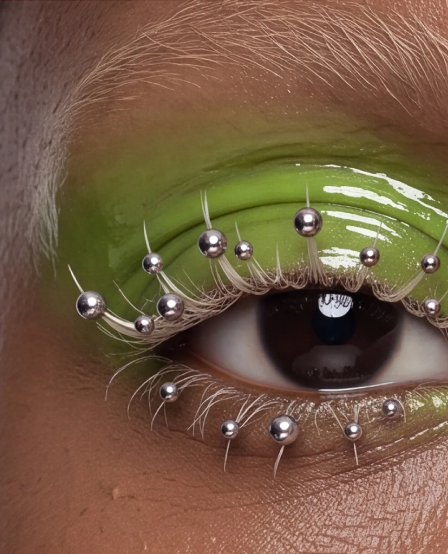 Close-up of a lime-green lid studded with silver beads.